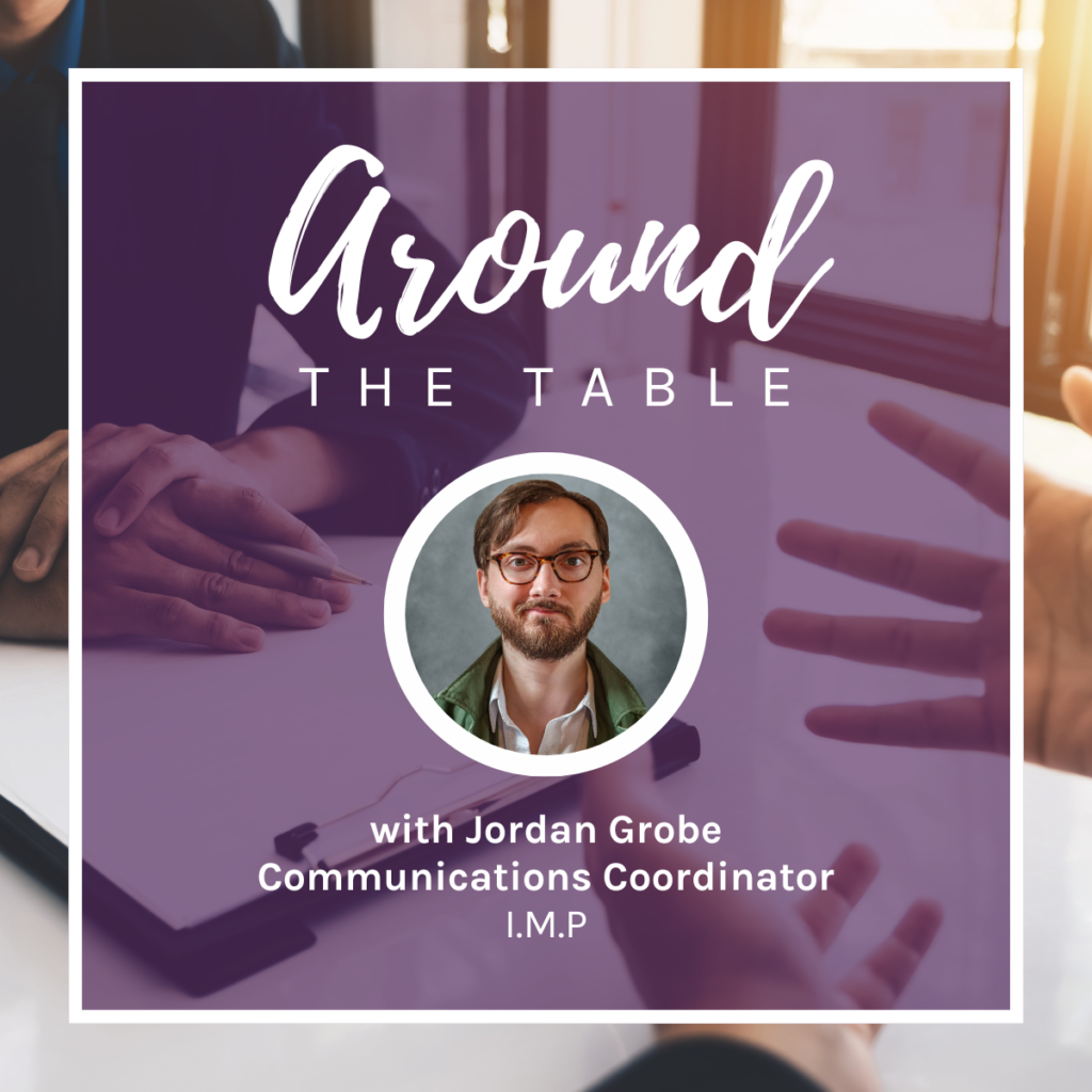 Scott Talan's headshot, superimposed over a designed background featuring two people sitting at a table.