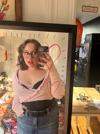 A mirror selfie of Ruby Werckman in their pink outfit for the Barbie showing.