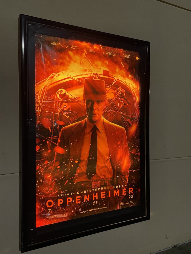 The theatrical poster for Oppenheimer, seen outside a movie theater.