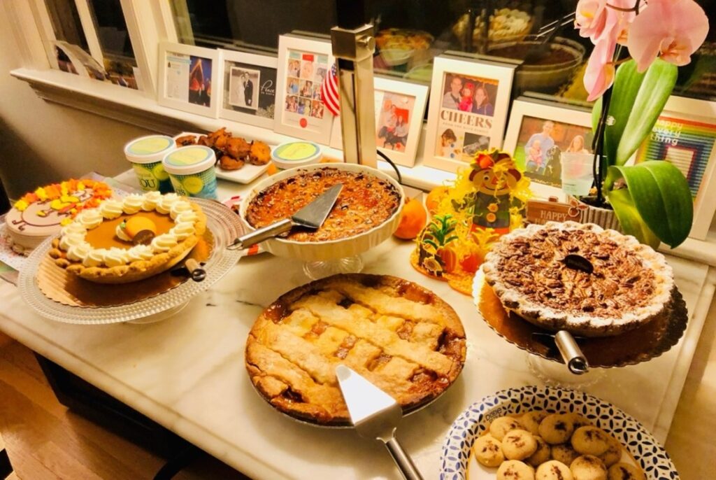 A variety of Thanksgiving pies, fried Oreos, and ice cream served on a dessert table.
