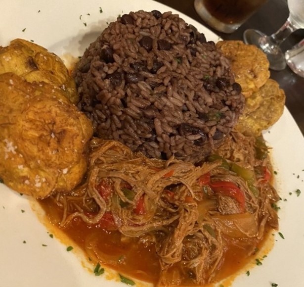 A traditional Cuban dish consisting of rice and beans, fried tostones or plantains, and ropa vieja or pulled beef.