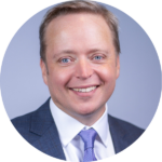 A circular headshot of Alexander.